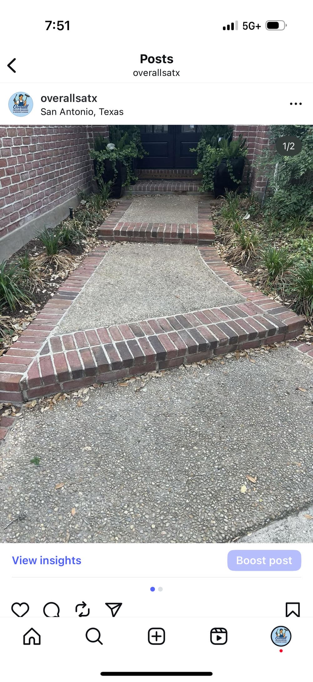 Curved brick and stone walkway leading to a black door in San Antonio, Texas.